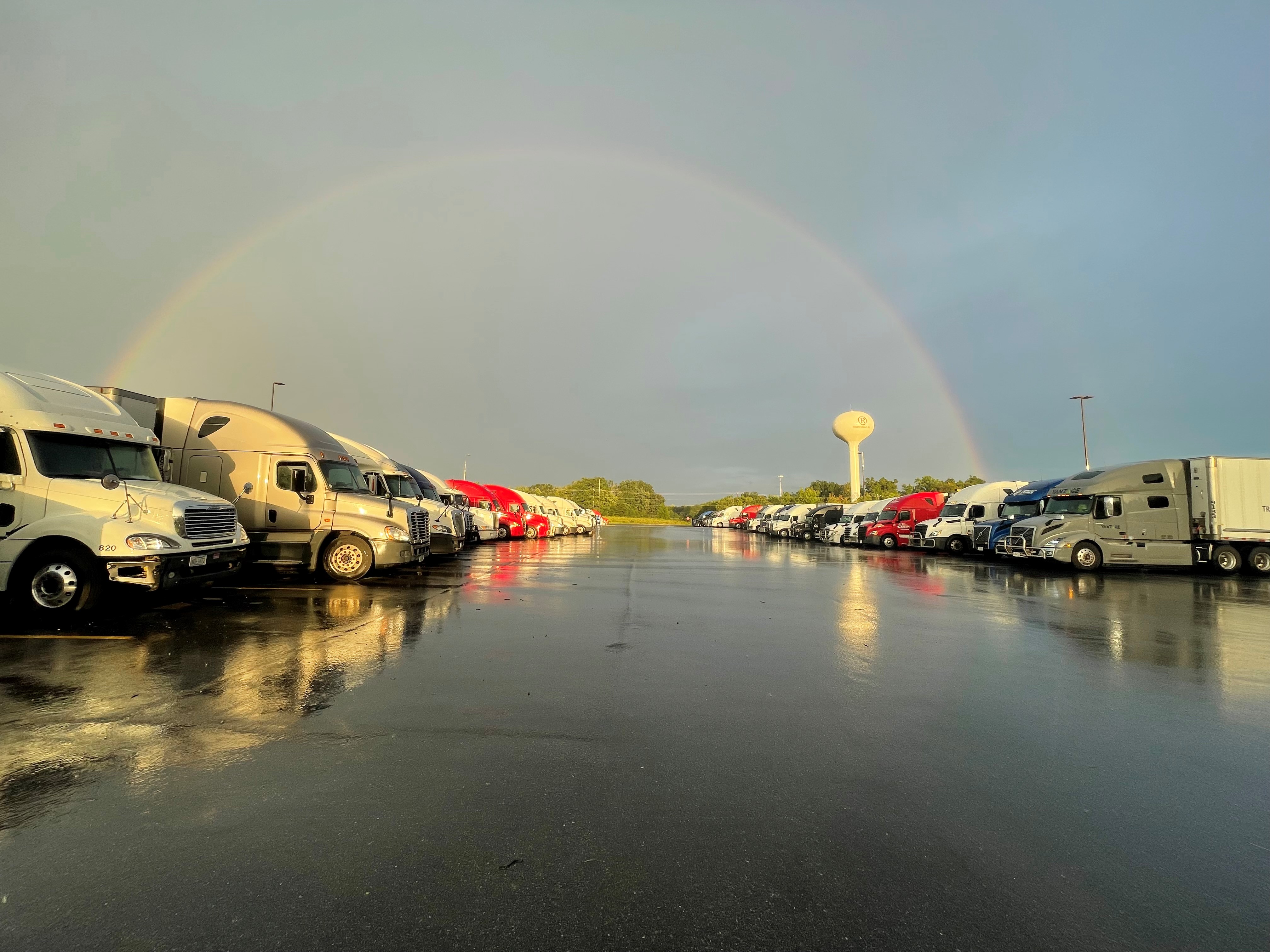 TruckerMatch Ai — trucks parked under a rainbow